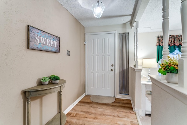 5312 Vermillion Trl, Arlington, TX 76017 - foyer with light wood-style floors and a textured ceiling