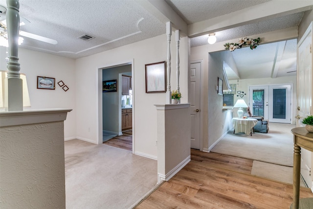 5312 Vermillion Trl, Arlington, TX 76017 - hall featuring a textured ceiling, light carpet, and light wood finished floors