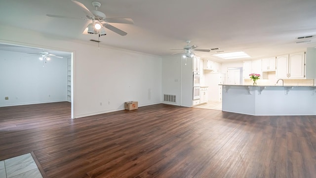 111 Scenic Dr, Dublin, TX 76446 - unfurnished living room featuring ceiling fan, wood finished floors, and crown molding