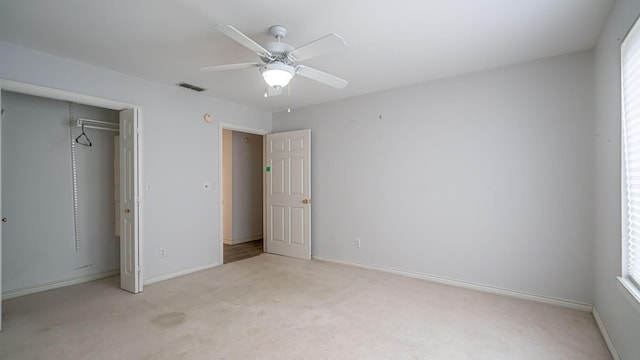 111 Scenic Dr, Dublin, TX 76446 - unfurnished bedroom featuring light colored carpet, multiple windows, and a ceiling fan