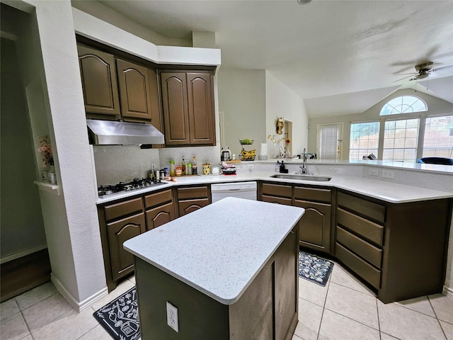 1412 Meadow Dr, Irving, TX 75063 - kitchen featuring under cabinet range hood, stainless steel gas stovetop, white dishwasher, a peninsula, and light countertops