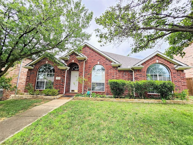 1412 Meadow Dr, Irving, TX 75063 - view of front of property with a front yard, brick siding, and roof with shingles