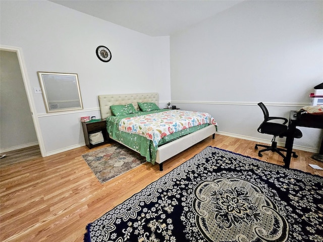 1412 Meadow Dr, Irving, TX 75063 - bedroom featuring wood finished floors and baseboards