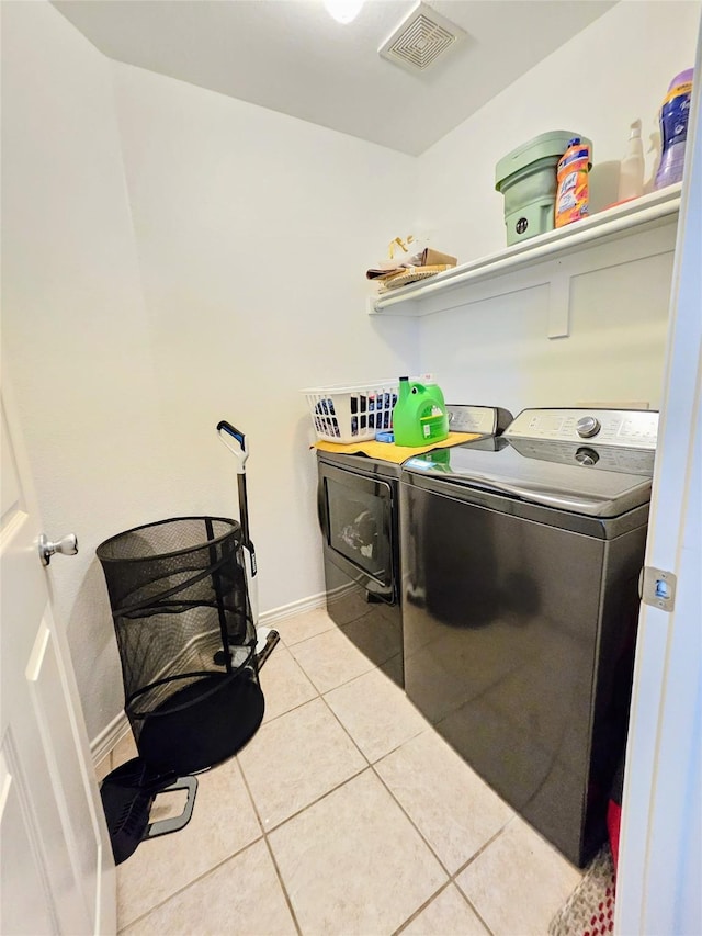 1412 Meadow Dr, Irving, TX 75063 - laundry area with washer and dryer and light tile patterned floors