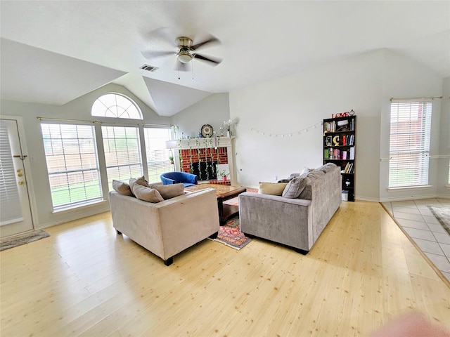1412 Meadow Dr, Irving, TX 75063 - living area with lofted ceiling, light wood-style floors, ceiling fan, and a fireplace
