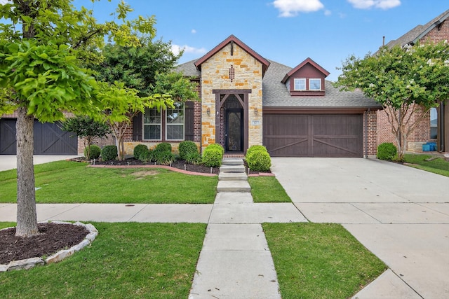 421 Fenceline Dr, Argyle, TX 76226 - view of front of home featuring stone siding, a front lawn, roof with shingles, concrete driveway, and brick siding