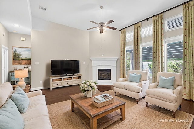 421 Fenceline Dr, Argyle, TX 76226 - living room featuring wood finished floors, a ceiling fan, and a glass covered fireplace