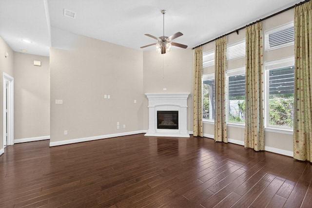 421 Fenceline Dr, Argyle, TX 76226 - unfurnished living room with a ceiling fan, a glass covered fireplace, and wood finished floors