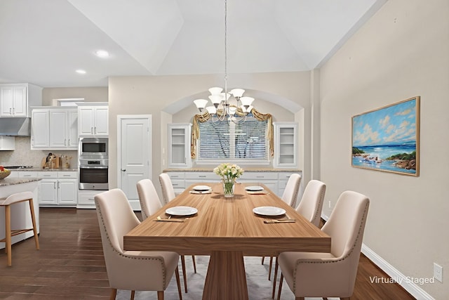 421 Fenceline Dr, Argyle, TX 76226 - dining area with a chandelier, dark wood-type flooring, lofted ceiling, recessed lighting, and arched walkways