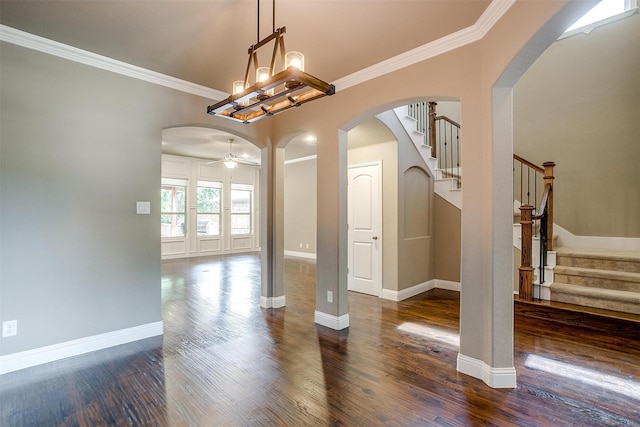302 Blue Stem Ln, Aledo, TX 76008 - empty room with arched walkways, crown molding, stairway, dark wood-style flooring, and a chandelier