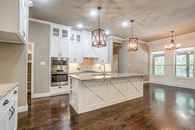302 Blue Stem Ln, Aledo, TX 76008 - kitchen featuring stainless steel appliances, decorative backsplash, a chandelier, dark wood finished floors, and light stone countertops