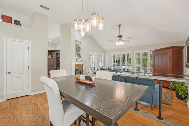 5229 Brettenmeadow Dr, Grapevine, TX 76051 - dining room featuring a ceiling fan, light wood-style flooring, vaulted ceiling, and a chandelier