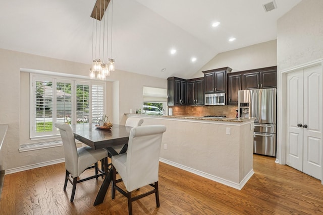 5229 Brettenmeadow Dr, Grapevine, TX 76051 - dining room with light wood-style floors, lofted ceiling, a chandelier, and recessed lighting