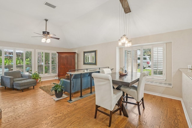 5229 Brettenmeadow Dr, Grapevine, TX 76051 - dining room featuring lofted ceiling, ceiling fan, light wood-type flooring, plenty of natural light, and a chandelier
