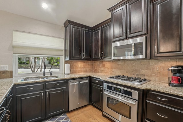 5229 Brettenmeadow Dr, Grapevine, TX 76051 - kitchen with stainless steel appliances, decorative backsplash, and light wood-style floors