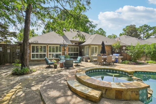 5229 Brettenmeadow Dr, Grapevine, TX 76051 - back of property featuring a patio, a shingled roof, a pool with connected hot tub, and outdoor dining space