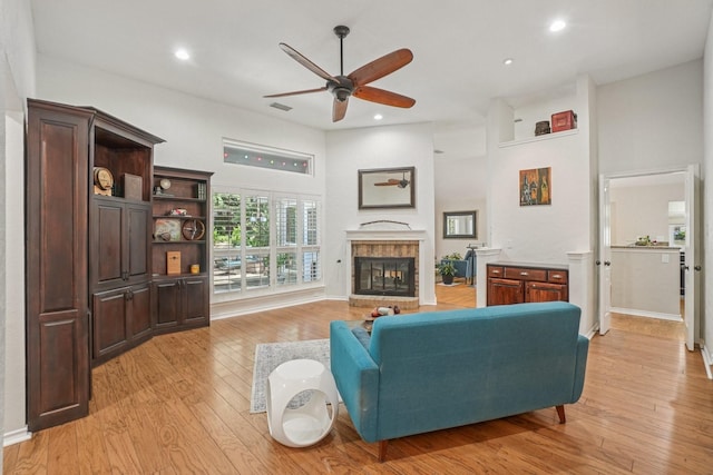 5229 Brettenmeadow Dr, Grapevine, TX 76051 - living room with ceiling fan, light wood-style floors, recessed lighting, a brick fireplace, and a towering ceiling