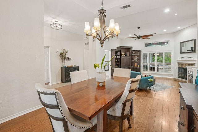 5229 Brettenmeadow Dr, Grapevine, TX 76051 - dining area with a ceiling fan, light wood finished floors, a chandelier, a glass covered fireplace, and recessed lighting