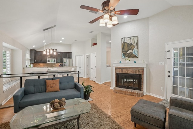 5229 Brettenmeadow Dr, Grapevine, TX 76051 - living area with a ceiling fan, light wood-type flooring, a fireplace, and high vaulted ceiling