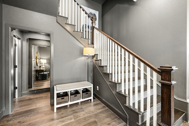 5495 Ashby Grove St, Dallas, TX 75209 - staircase featuring a textured wall and wood finished floors