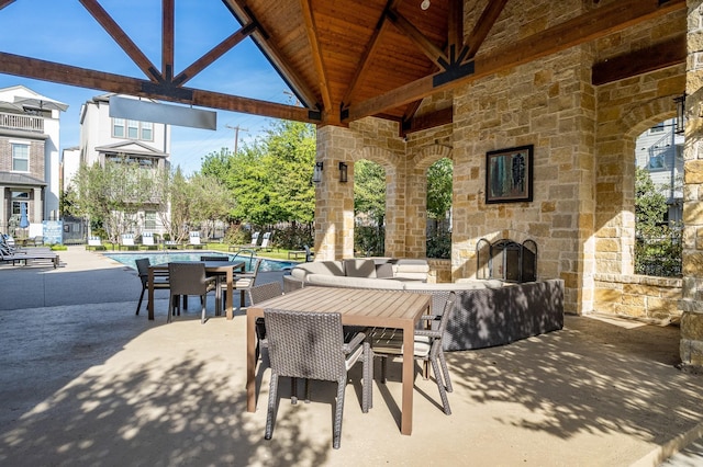5495 Ashby Grove St, Dallas, TX 75209 - view of patio / terrace with an outdoor stone fireplace, a community pool, and a gazebo
