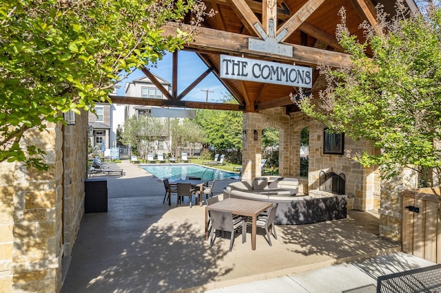 5495 Ashby Grove St, Dallas, TX 75209 - view of patio with an outdoor stone fireplace, a gazebo, and a community pool