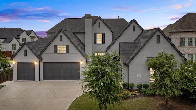 3387 Bellcrest Way, Celina, TX 75009 - french country style house featuring a shingled roof, driveway, brick siding, and a chimney