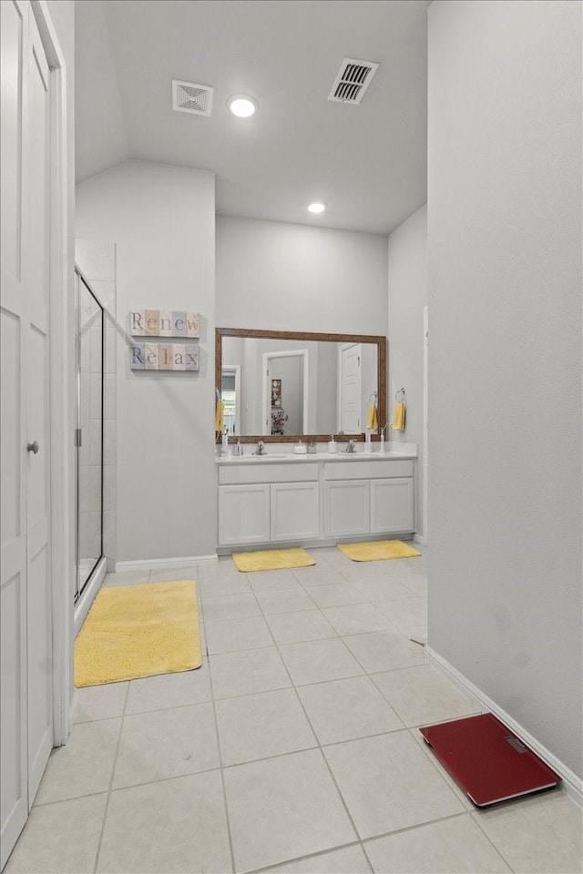 7118 Pampas Pl, Grand Prairie, TX 76804 - bathroom featuring a shower stall, double vanity, tile patterned flooring, and lofted ceiling
