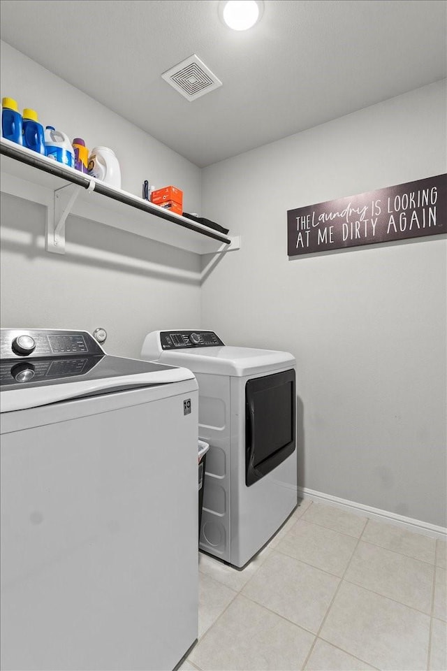 7118 Pampas Pl, Grand Prairie, TX 76804 - laundry room with washing machine and dryer and light tile patterned floors