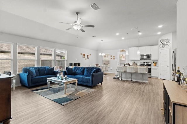 7118 Pampas Pl, Grand Prairie, TX 76804 - living area with light wood-type flooring, a ceiling fan, vaulted ceiling, a chandelier, and recessed lighting