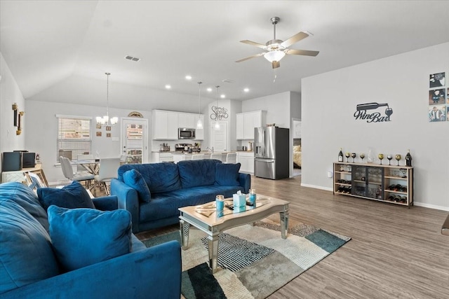 7118 Pampas Pl, Grand Prairie, TX 76804 - living room featuring a ceiling fan, a chandelier, wood finished floors, and lofted ceiling