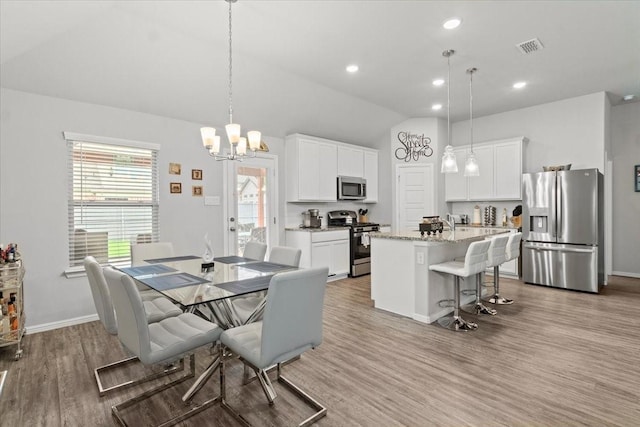 7118 Pampas Pl, Grand Prairie, TX 76804 - dining room featuring lofted ceiling, wood finished floors, a chandelier, and recessed lighting