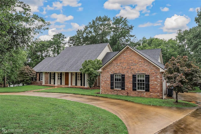 1078 Waters Edge Cir, Shreveport, LA 71106 - view of front of house with brick siding, a front lawn, and roof with shingles