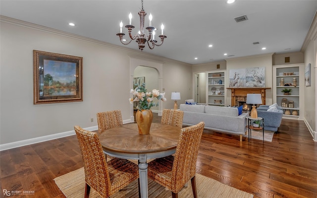 1078 Waters Edge Cir, Shreveport, LA 71106 - dining space featuring a chandelier, arched walkways, crown molding, dark wood-style floors, and recessed lighting
