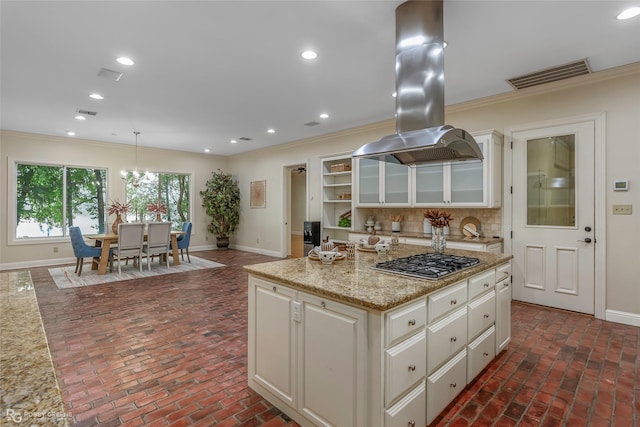 1078 Waters Edge Cir, Shreveport, LA 71106 - kitchen featuring stainless steel gas stovetop, brick floors, island exhaust hood, crown molding, and recessed lighting