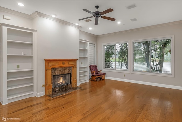 1078 Waters Edge Cir, Shreveport, LA 71106 - living area with crown molding, built in shelves, ceiling fan, a high end fireplace, and recessed lighting