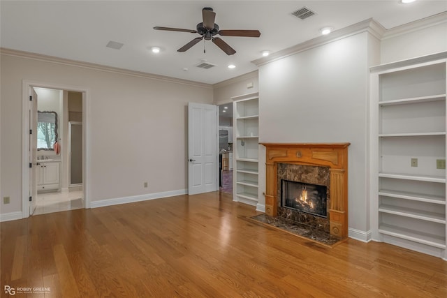 1078 Waters Edge Cir, Shreveport, LA 71106 - unfurnished living room with ornamental molding, a ceiling fan, built in shelves, a fireplace, and wood finished floors