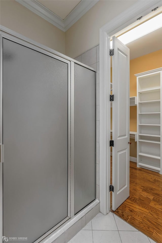 1078 Waters Edge Cir, Shreveport, LA 71106 - bathroom with ornamental molding, a shower stall, a spacious closet, and tile patterned flooring