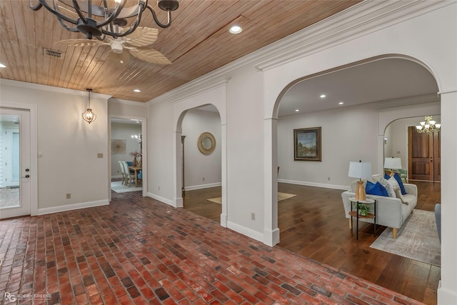 1078 Waters Edge Cir, Shreveport, LA 71106 - living room featuring arched walkways, a chandelier, brick floors, crown molding, and recessed lighting