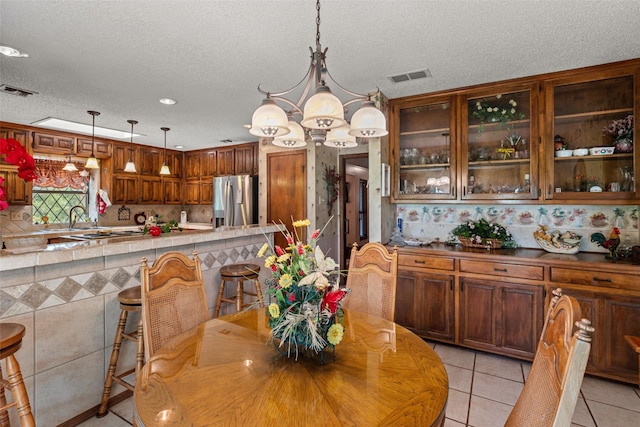 3503 Red Bud Dr, Weatherford, TX 76087 - dining area with a chandelier, light tile patterned flooring, a textured ceiling, and recessed lighting