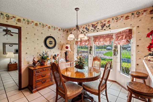 3503 Red Bud Dr, Weatherford, TX 76087 - dining space featuring wallpapered walls, light tile patterned flooring, a textured ceiling, a chandelier, and a ceiling fan