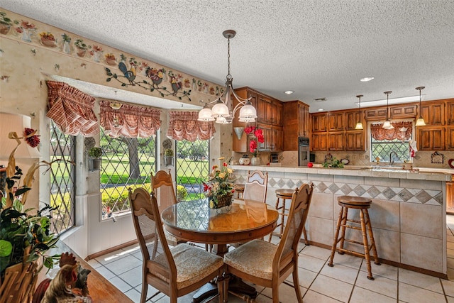 3503 Red Bud Dr, Weatherford, TX 76087 - dining area with light tile patterned floors, a textured ceiling, recessed lighting, and a chandelier