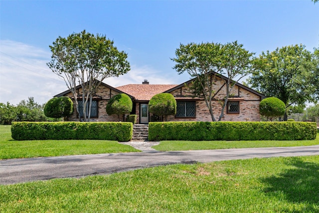 3503 Red Bud Dr, Weatherford, TX 76087 - view of front facade with brick siding, a front yard, and roof with shingles