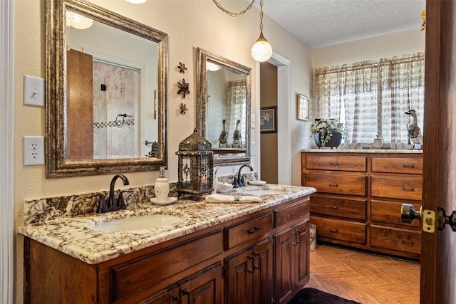 3503 Red Bud Dr, Weatherford, TX 76087 - full bathroom with double vanity and a textured ceiling