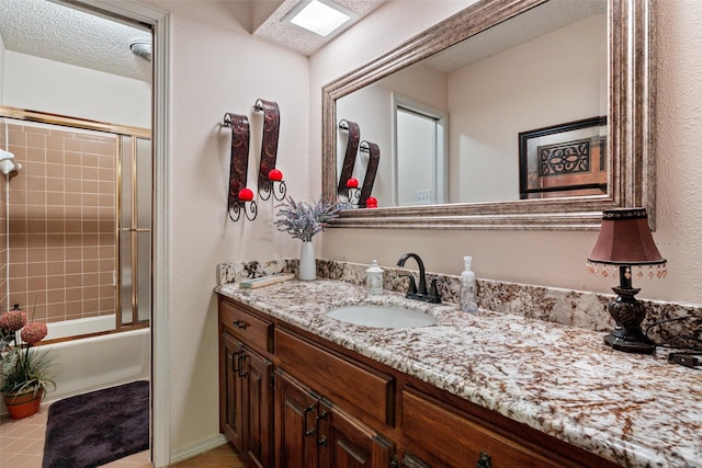 3503 Red Bud Dr, Weatherford, TX 76087 - full bath featuring vanity, shower / bath combination with glass door, and a textured wall
