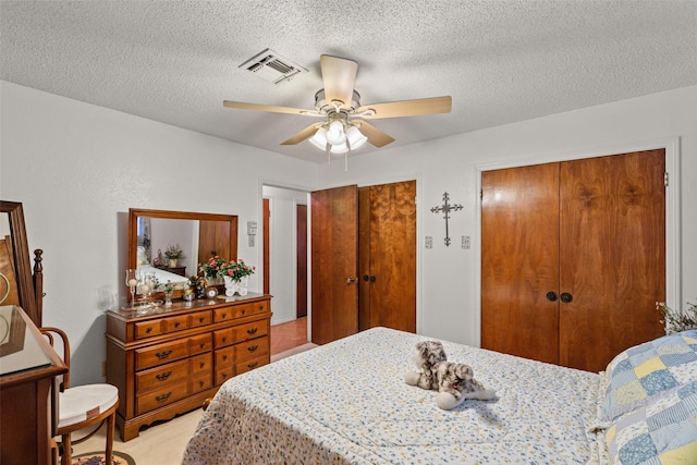 3503 Red Bud Dr, Weatherford, TX 76087 - bedroom with multiple closets, a textured ceiling, and ceiling fan