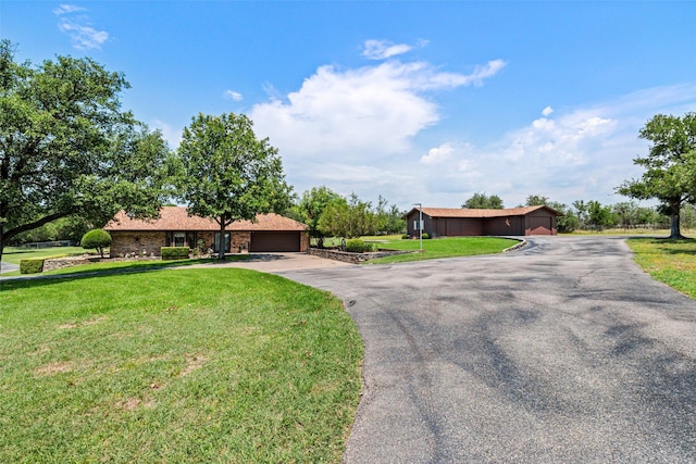 3503 Red Bud Dr, Weatherford, TX 76087 - ranch-style home featuring a front yard, an attached garage, and driveway