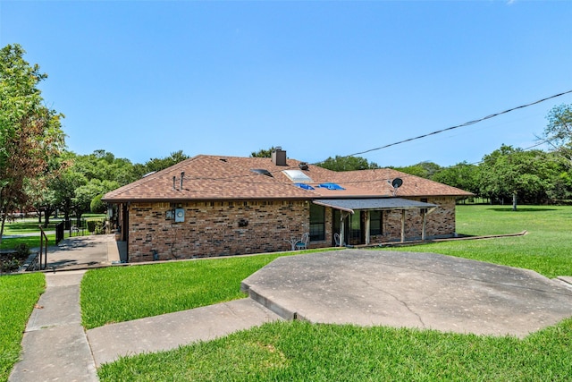 3503 Red Bud Dr, Weatherford, TX 76087 - back of property featuring a yard, brick siding, a chimney, and roof with shingles