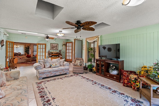 3503 Red Bud Dr, Weatherford, TX 76087 - tiled living room with a ceiling fan, french doors, and a textured ceiling