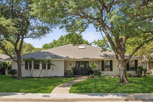 9735 Trevor Dr, Dallas, TX 75243 - view of front of house featuring a front yard and a shingled roof